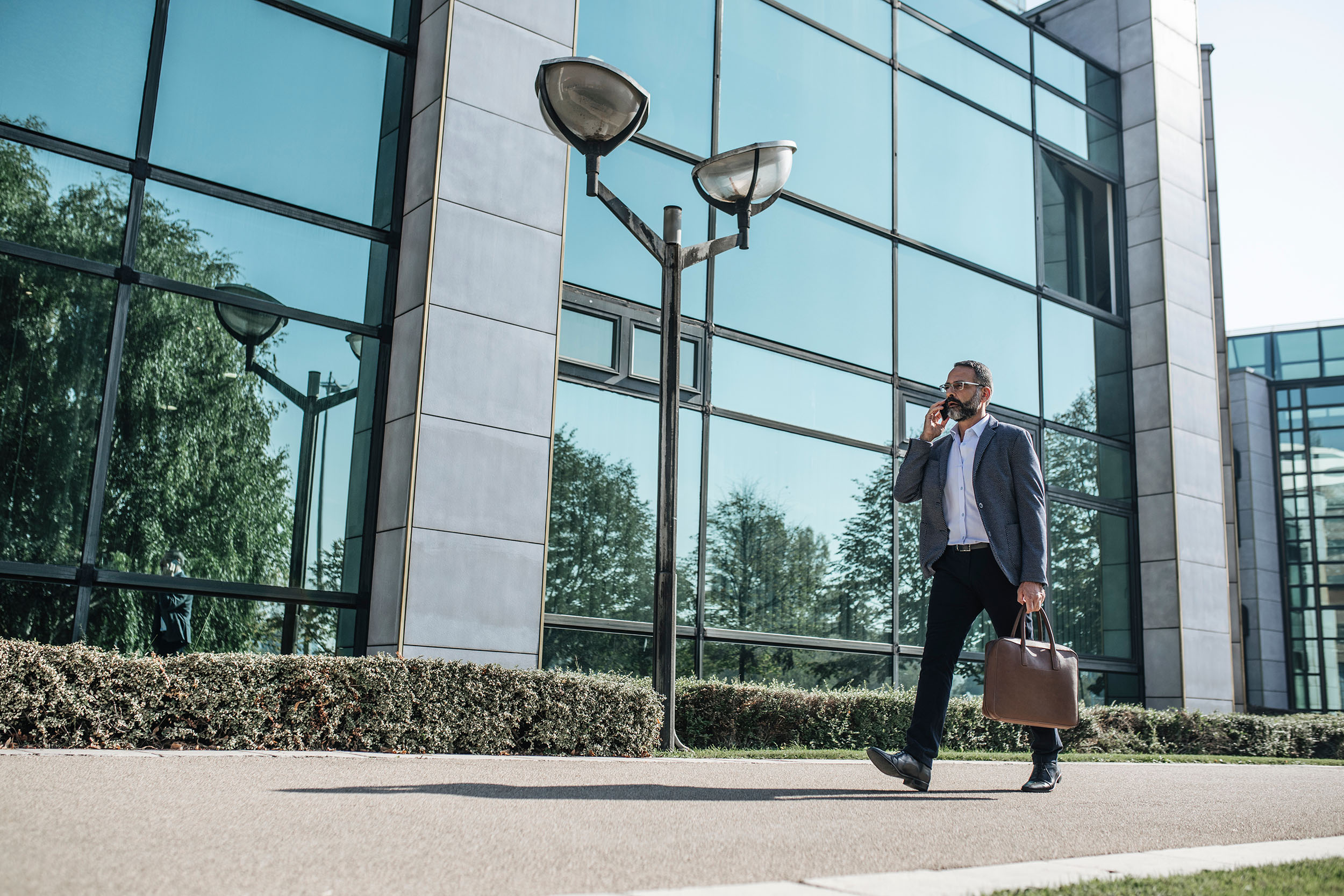 Businessman Talking on Cell Phone - Contact Blue Sky Ambition